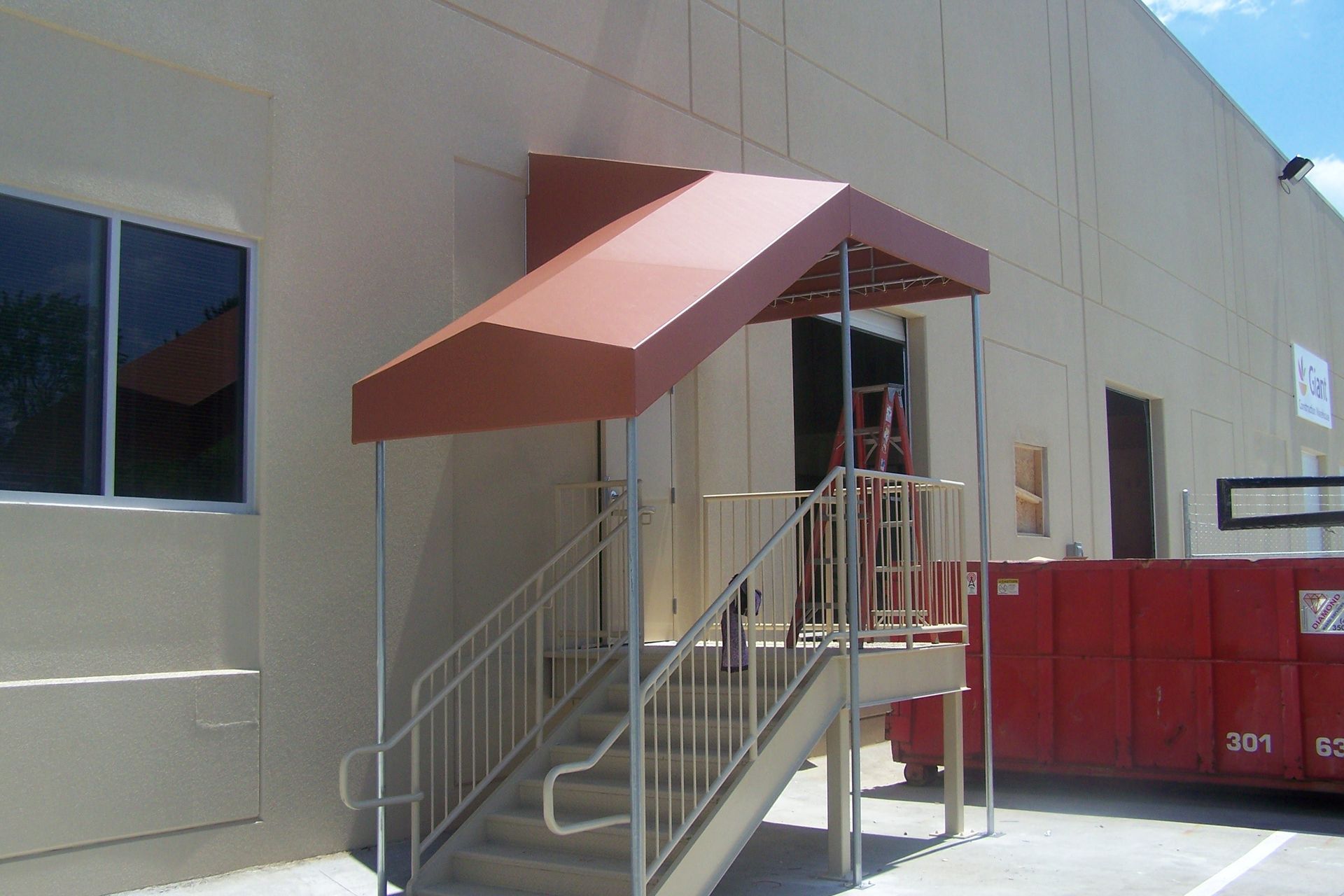 A staircase with a red awning over it