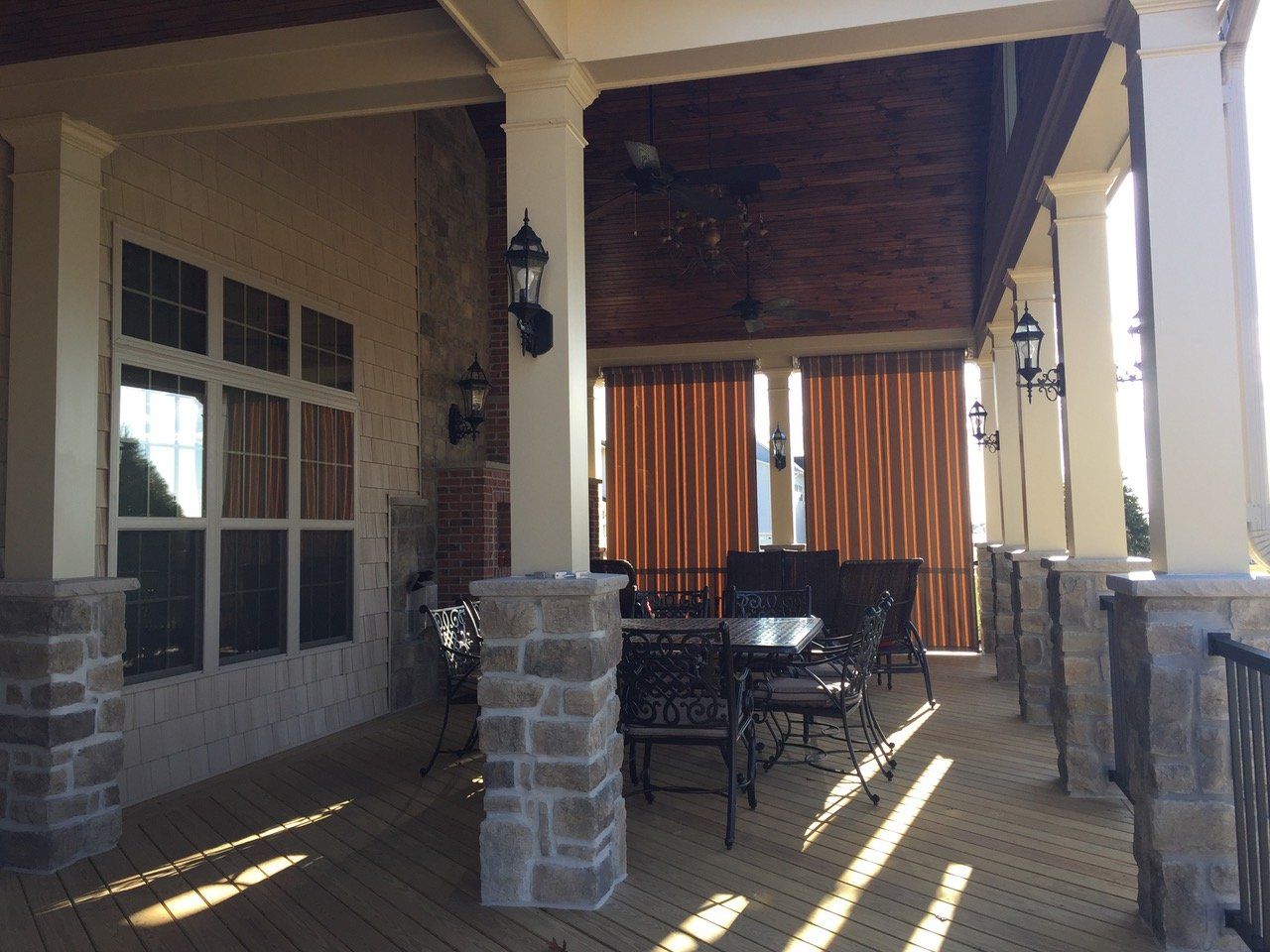 A patio with a table and chairs under a canopy