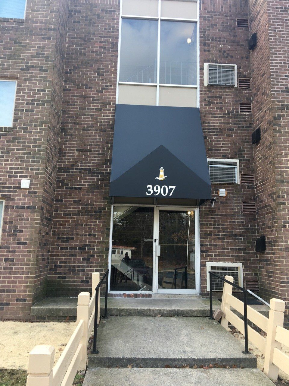 A black awning is installed in building