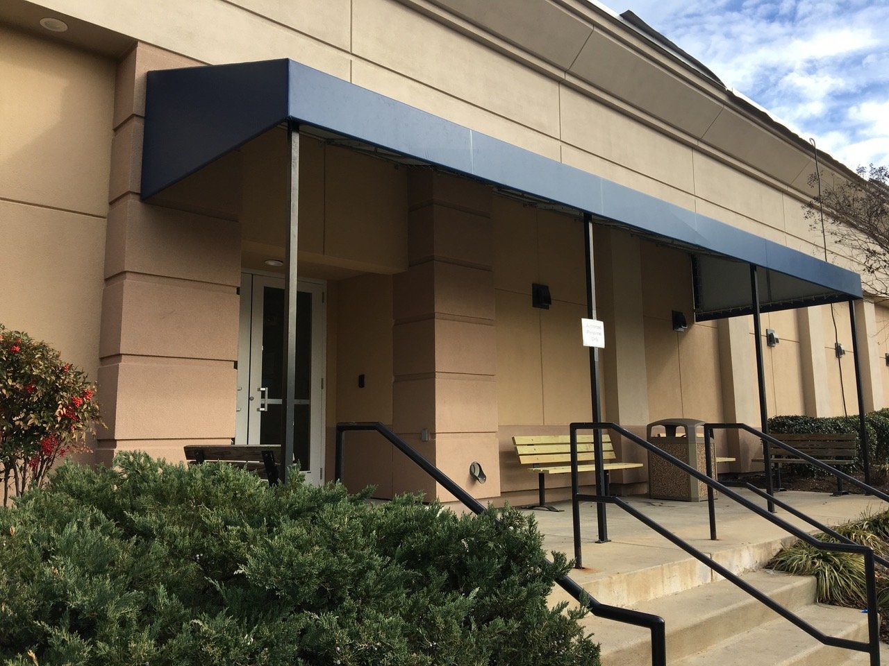 A building with a canopy and stairs leading up to it