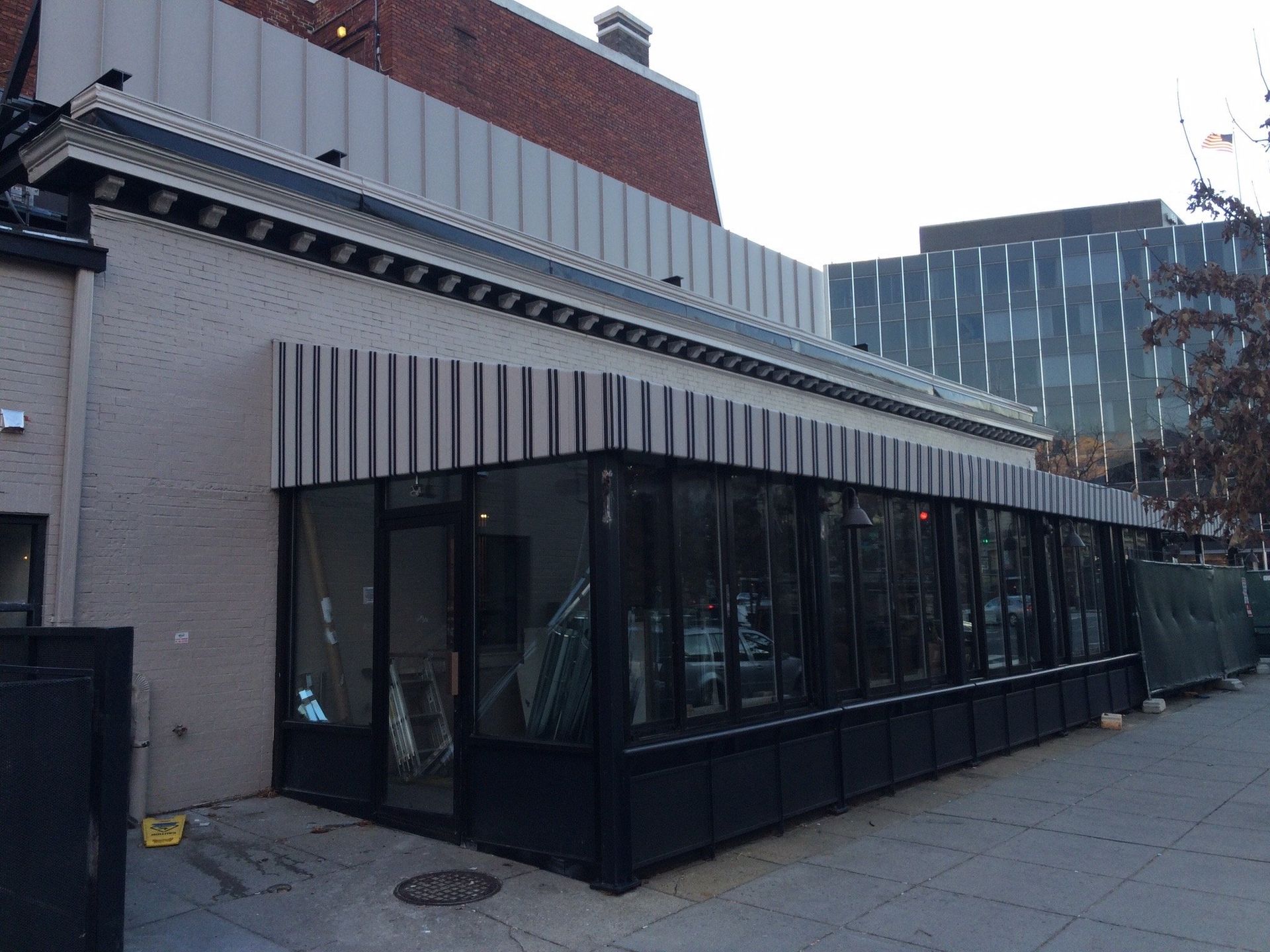 A building with a lot of windows and a brick building in the background