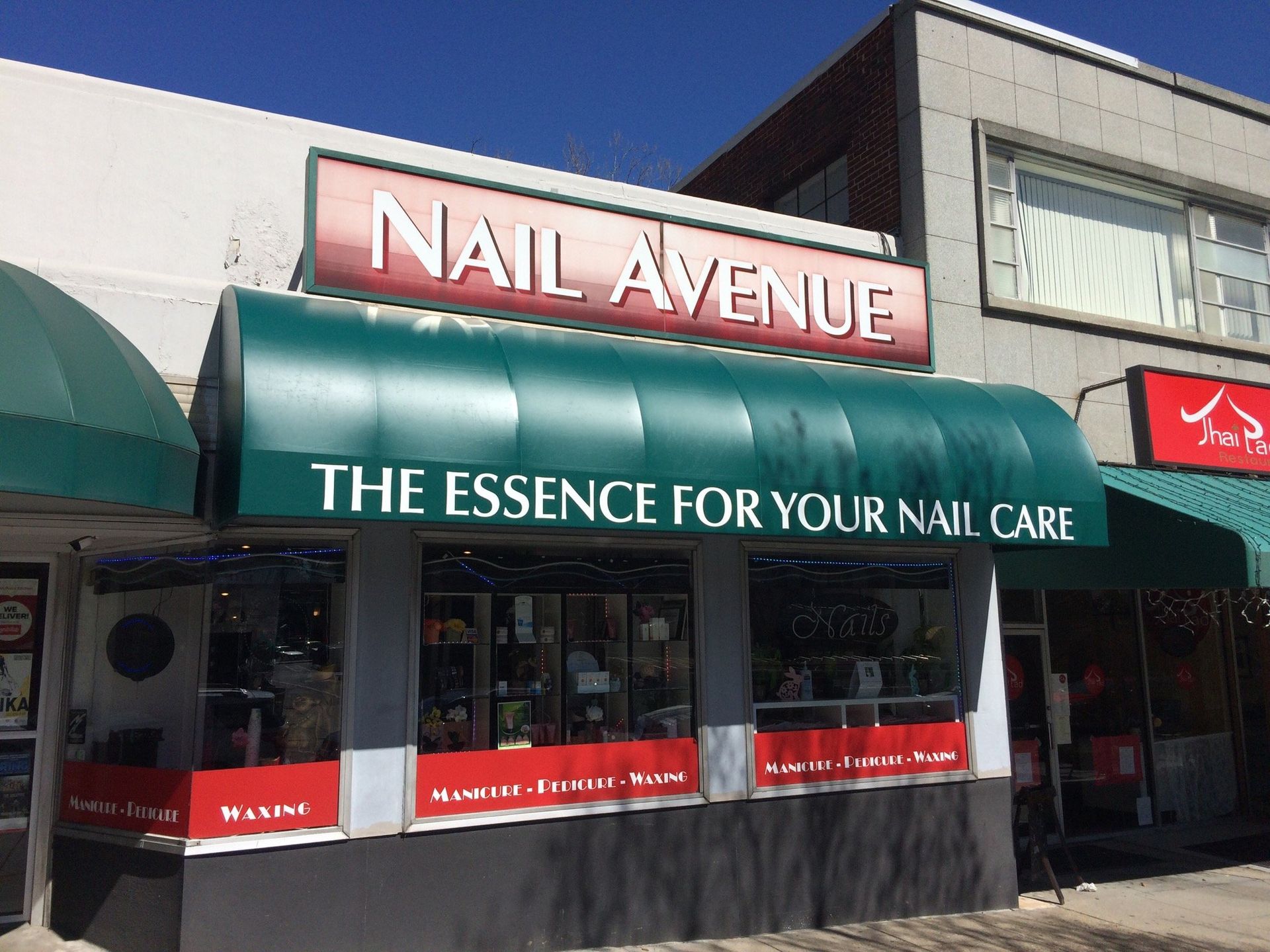 A brick building with a red awning over the entrance