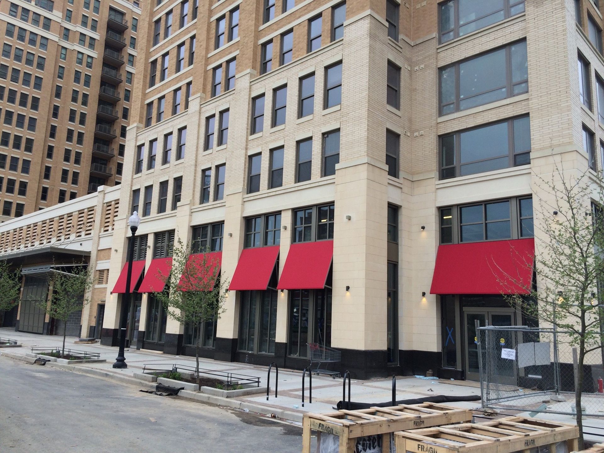 A large building with red awnings on the windows