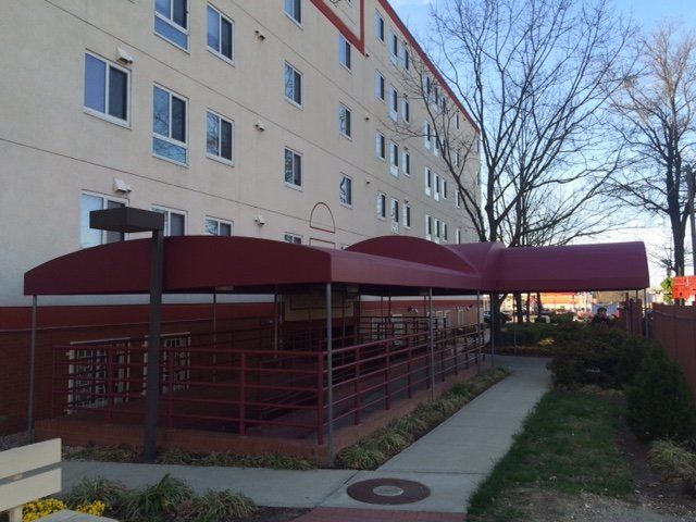 A large building with a red awning over the entrance