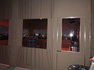 A man is standing in a room with a window and a door