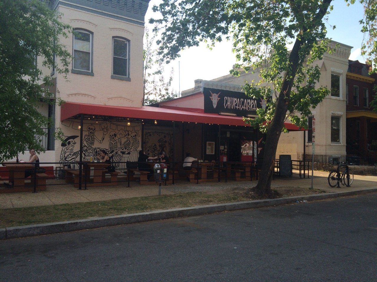 A restaurant with a red awning