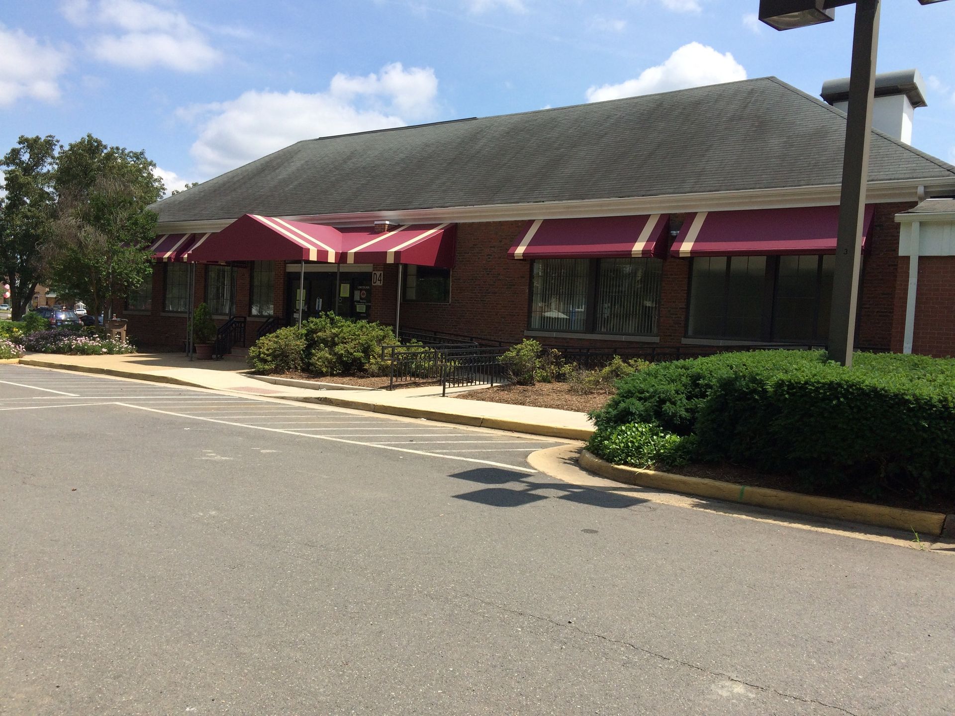A large brick building with red awnings on the windows