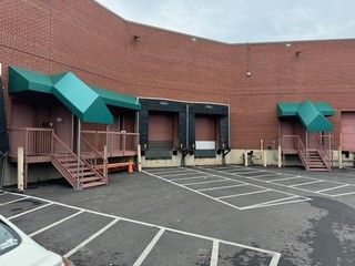 A brick building with a lot of loading docks and stairs