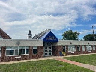 A large brick building with a blue awning over the entrance