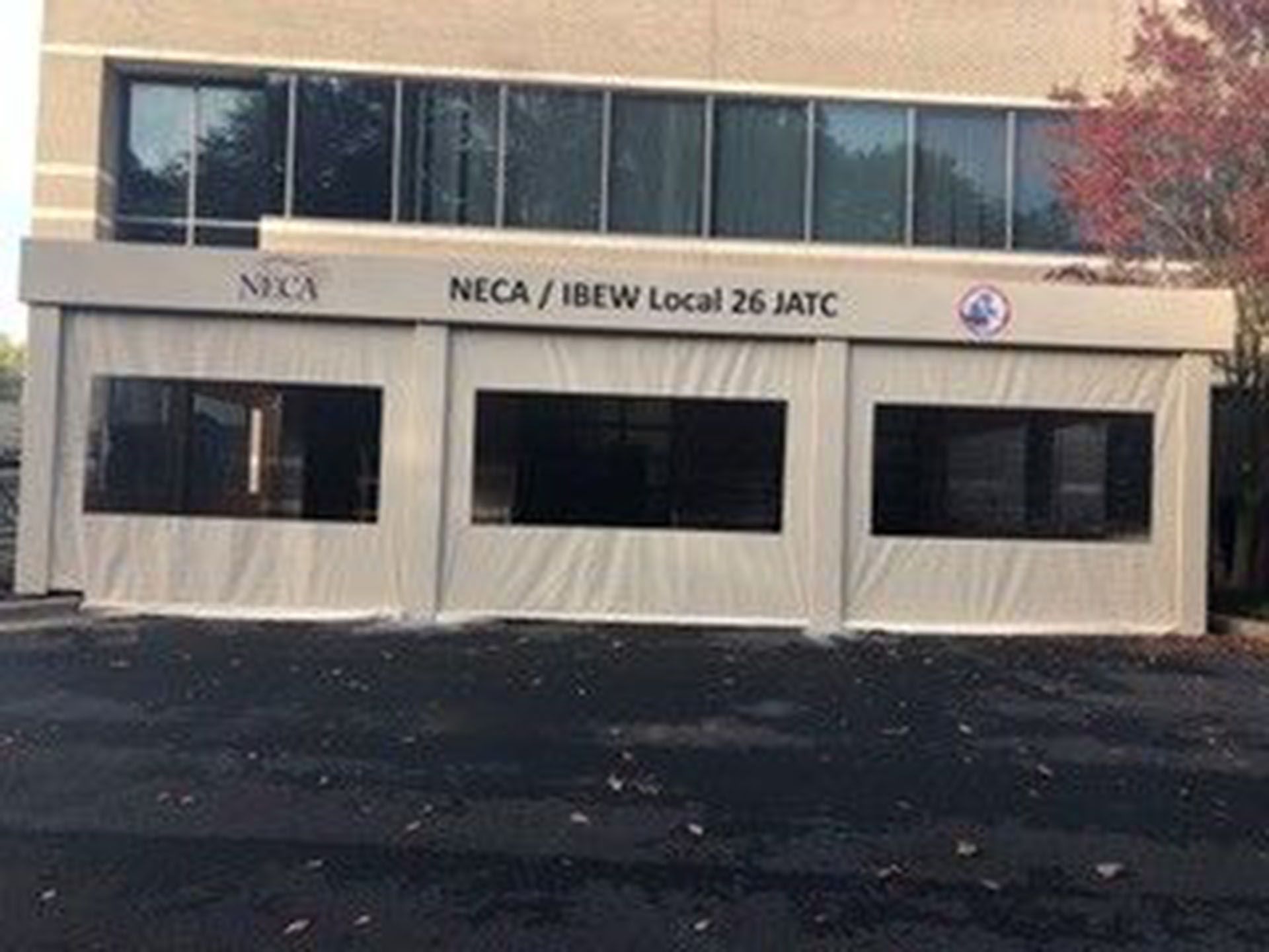 A restaurant with tables and chairs outside with blue umbrellas.