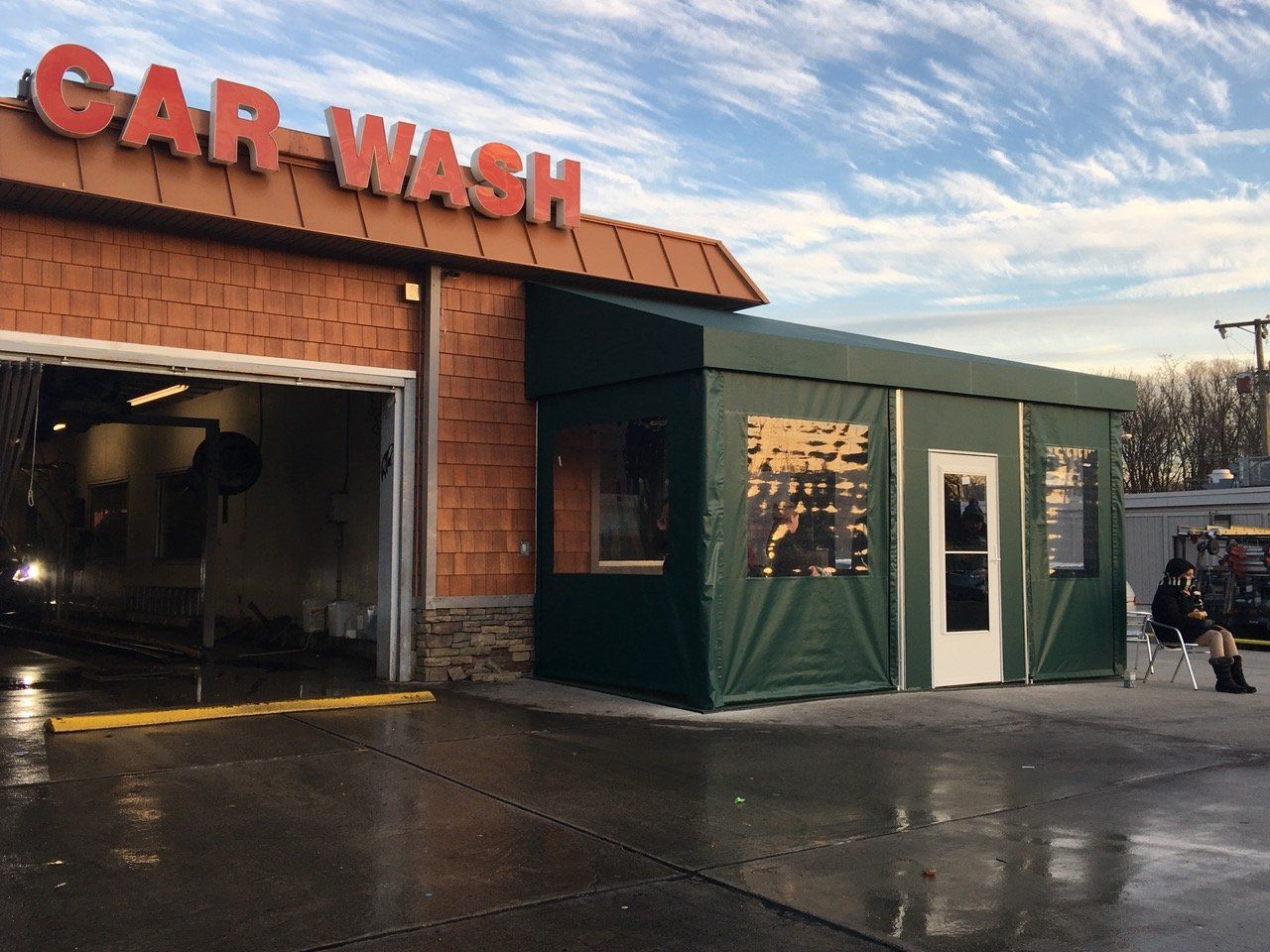 A car wash with a green tent in front of it