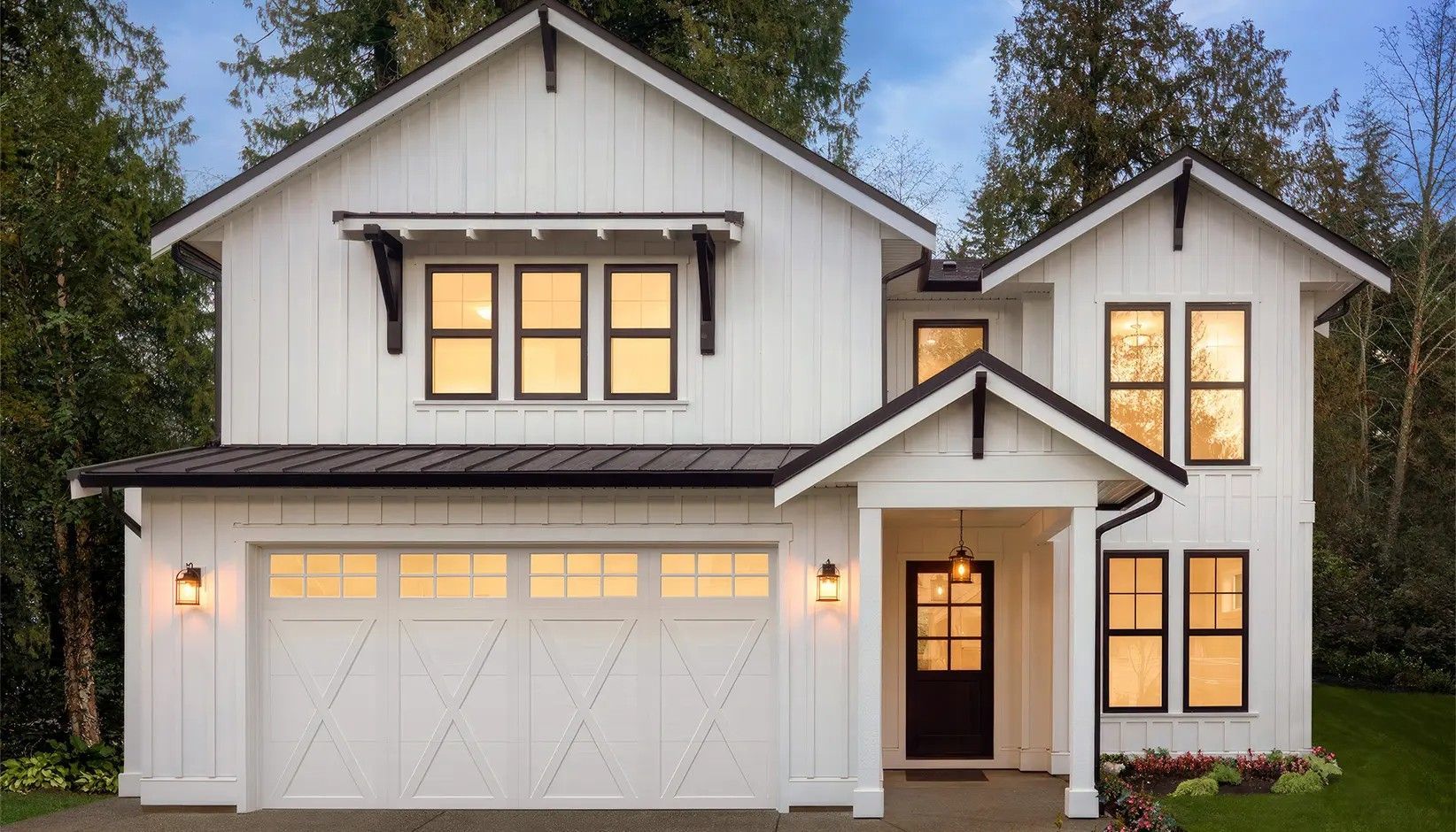 Modern two-story white farmhouse with vertical siding, a dark roof, a two-car garage, and a covered front entryway.