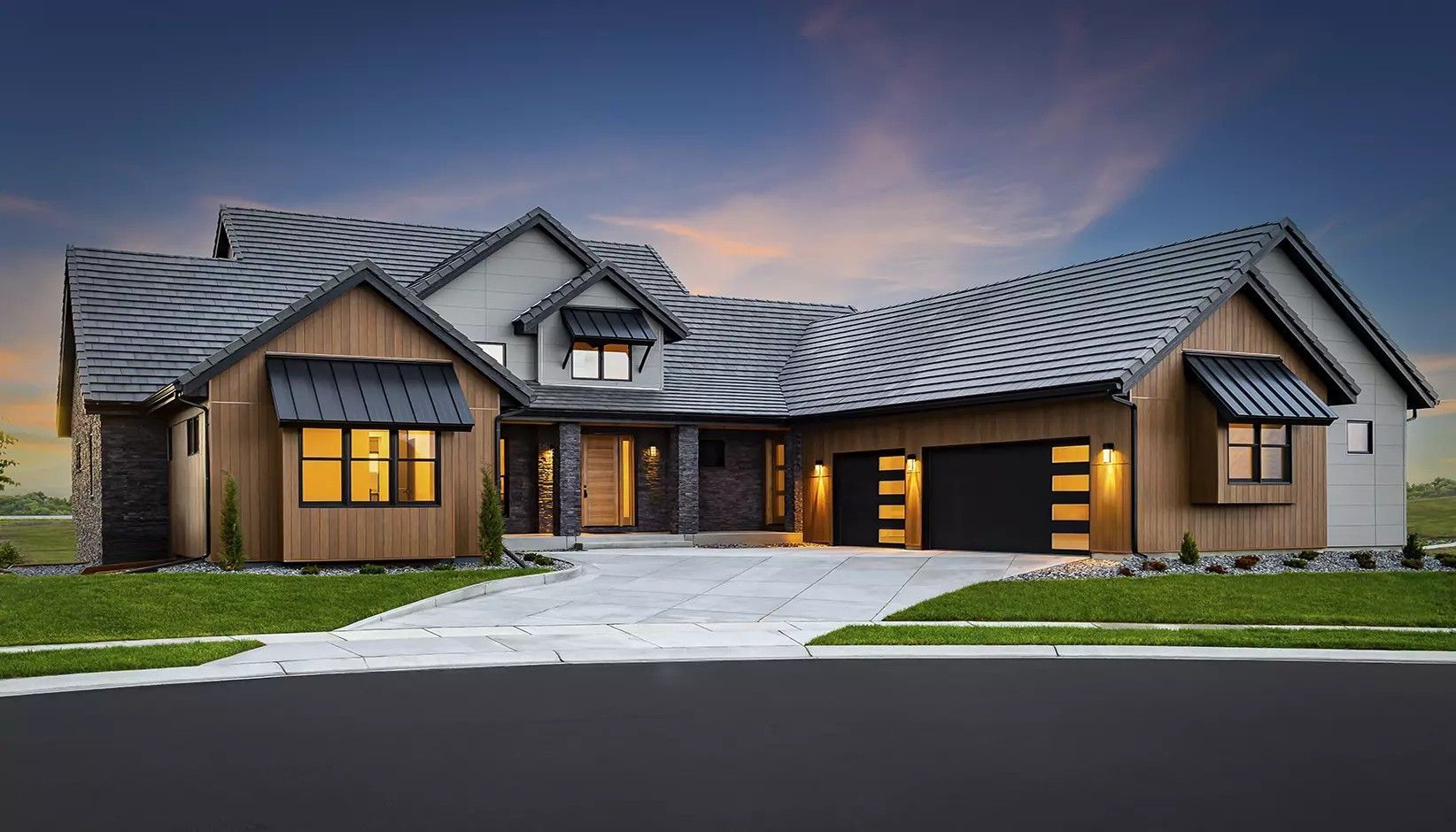 A single-story suburban house with wooden siding, stone accents, and a dark-tiled roof at twilight.