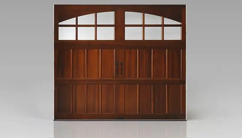 A brown wooden carriage-style garage door with an arched window design featuring eight glass panes.