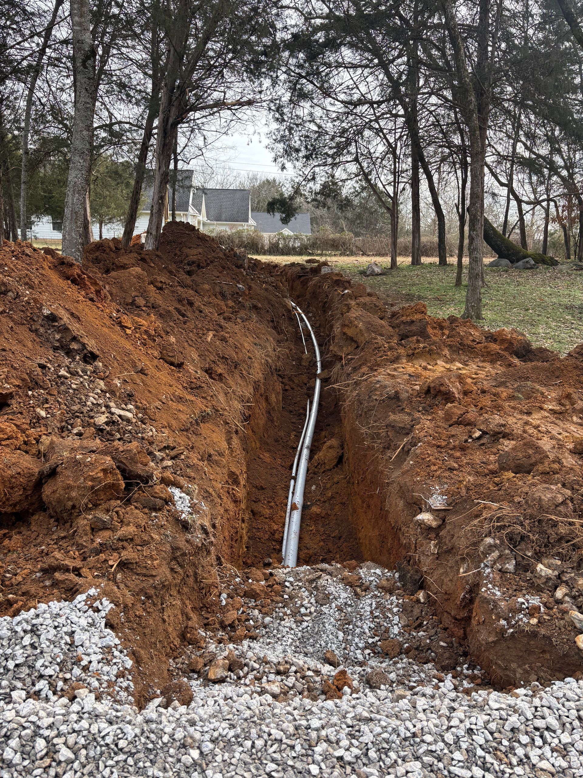 A pipe is being installed in a hole in the ground.