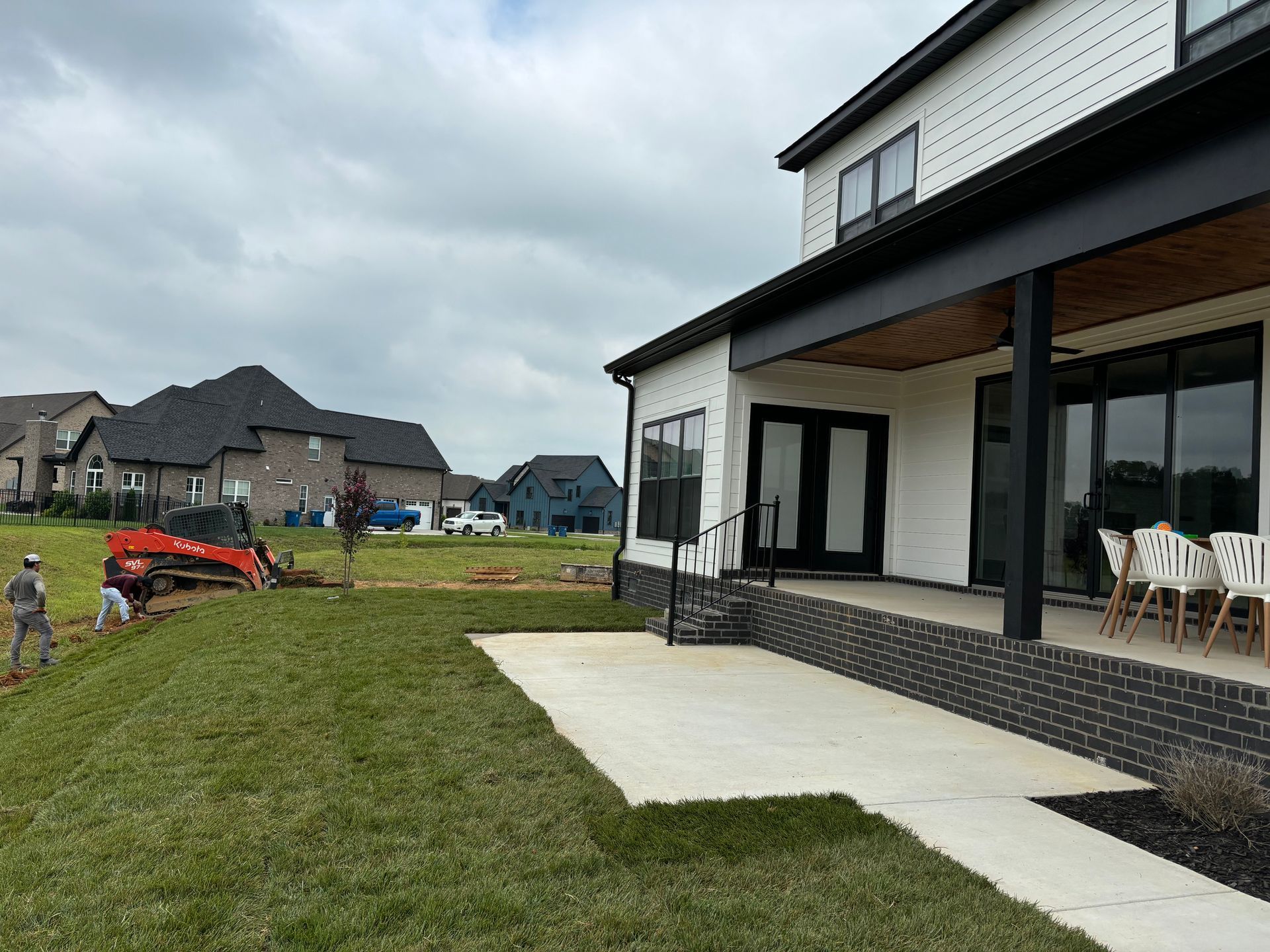 A large white house with a large lawn in front of it.