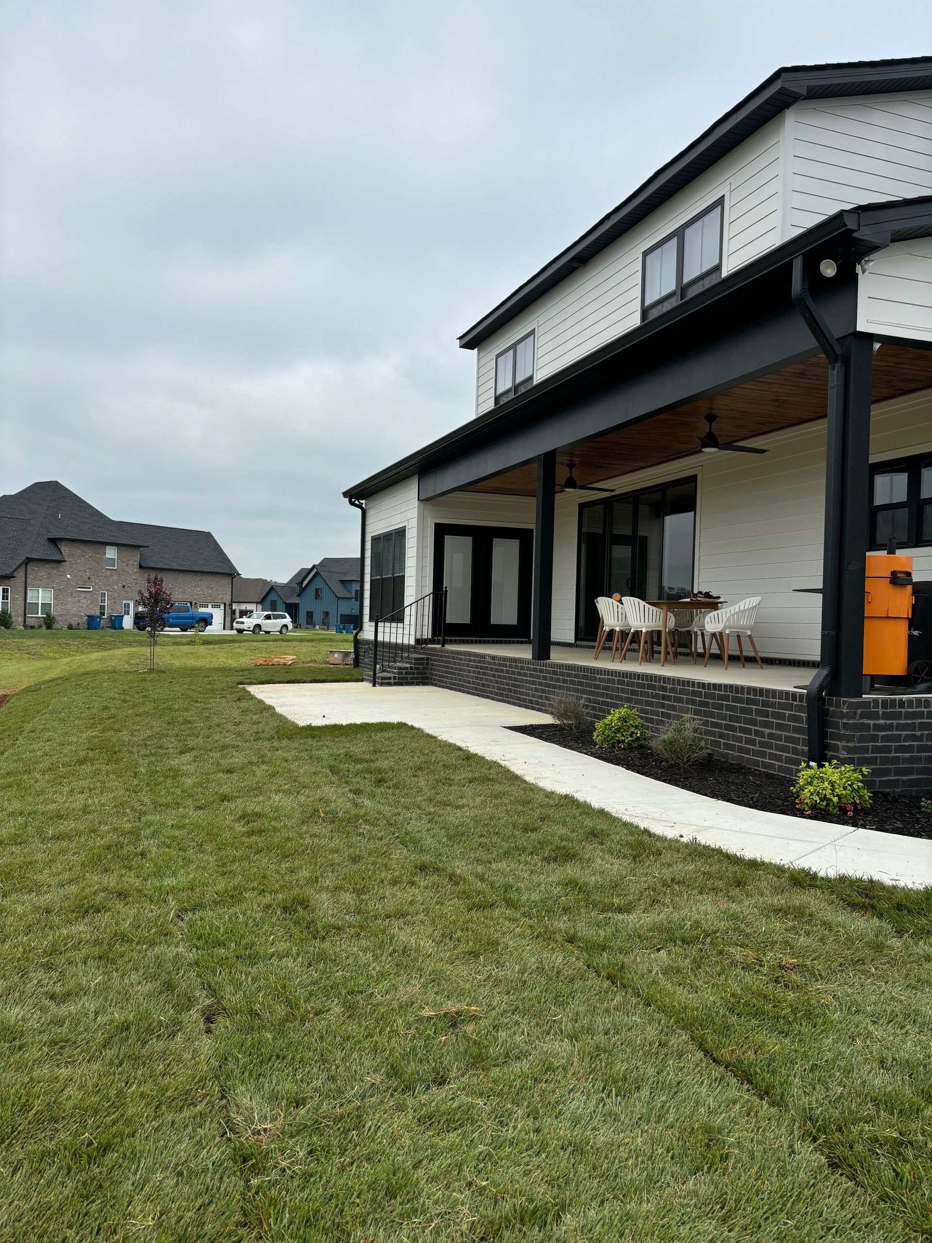 A large house with a large lawn in front of it.