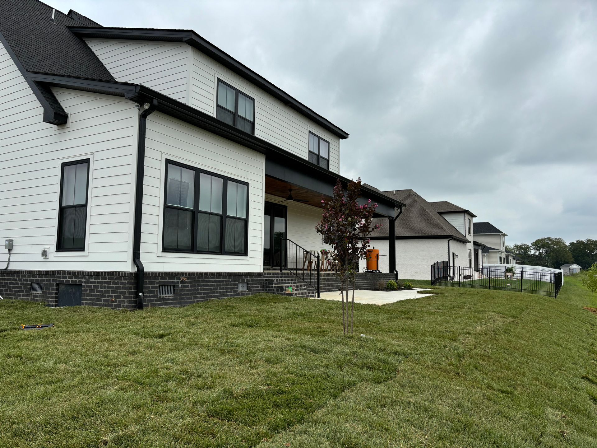 A large white house with a large lawn in front of it.