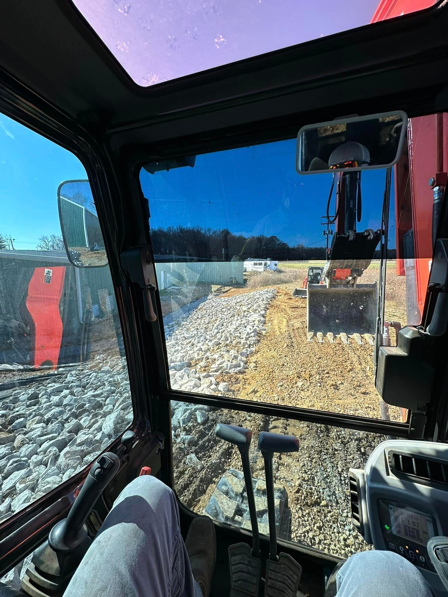 a person is sitting in the driver 's seat of a bulldozer .