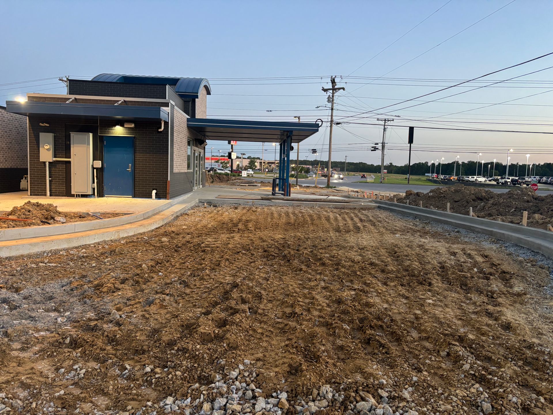 A building is being built in the middle of a dirt field.