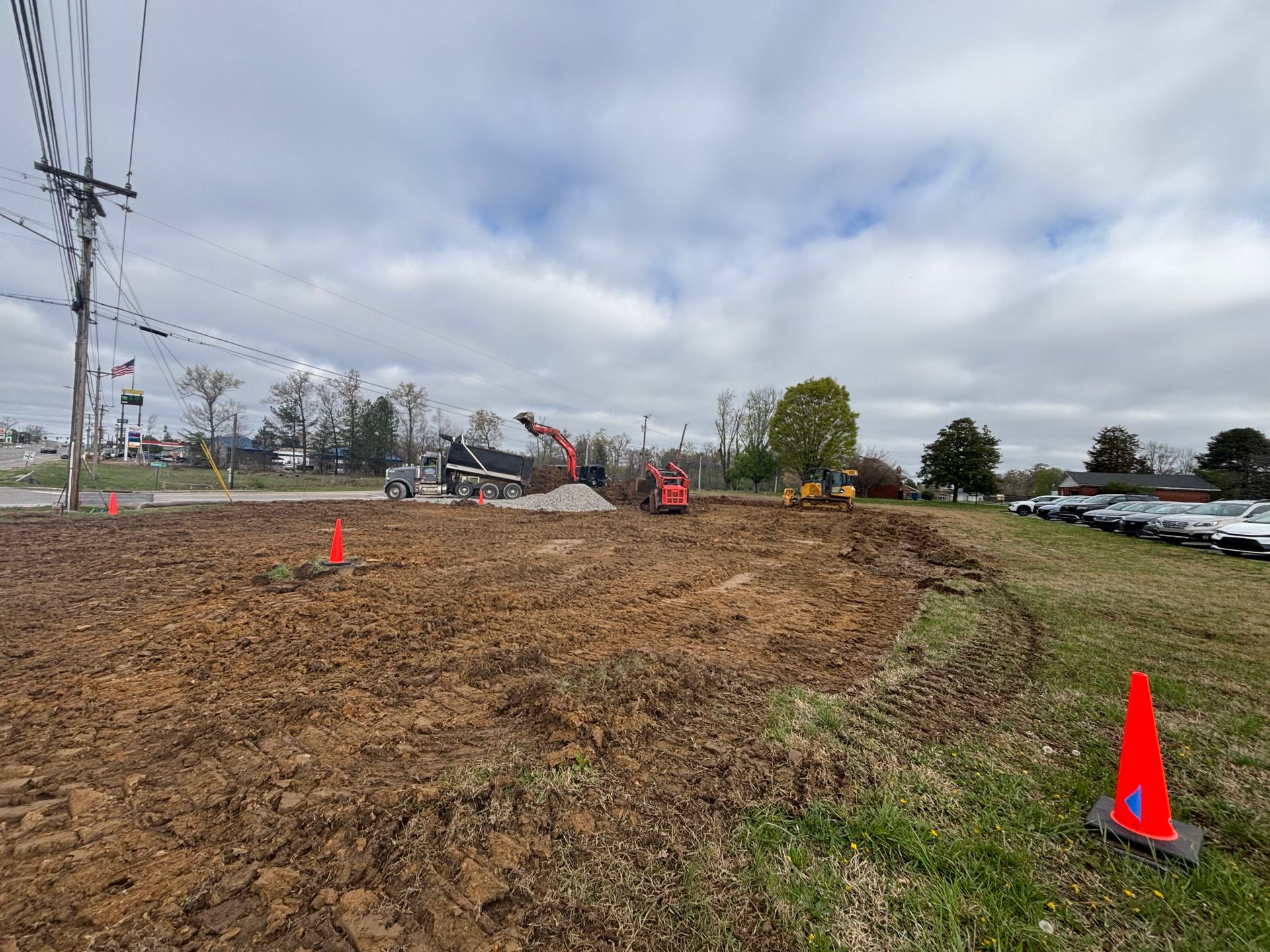 A construction site with a lot of dirt and cones.