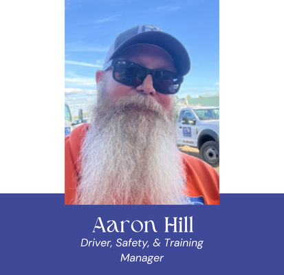 Man with a long beard wearing sunglasses and a cap, identified as Aaron Hill, Driver, Safety & Training Manager.