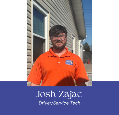 Man in orange polo shirt standing outside a building. Text: Josh Zajac, Driver/Service Tech.