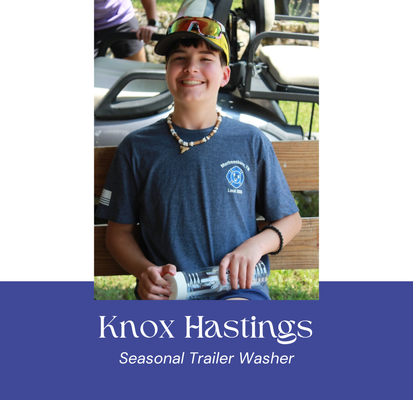 Knox Hastings, seasonal trailer washer, smiles while holding a water bottle, blue shirt, baseball cap.