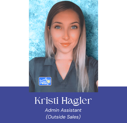 Kristi Hagler, Admin Assistant, smiling with light blue background. Blue collar shirt with logo.