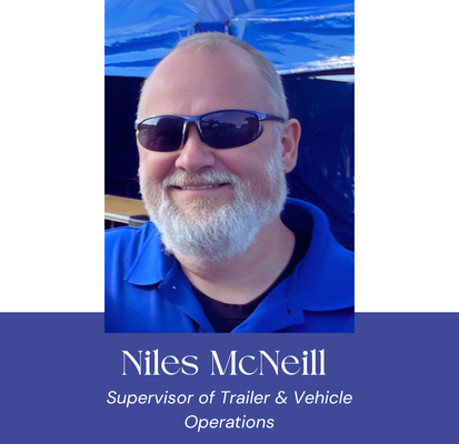 Man with sunglasses and beard, identified as Niles McNeill, Supervisor of Trailer & Vehicle Operations.