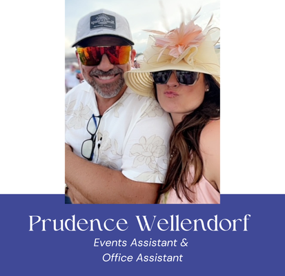 Man and woman smiling, at an event. Man in cap and sunglasses. Woman with hat and sunglasses.