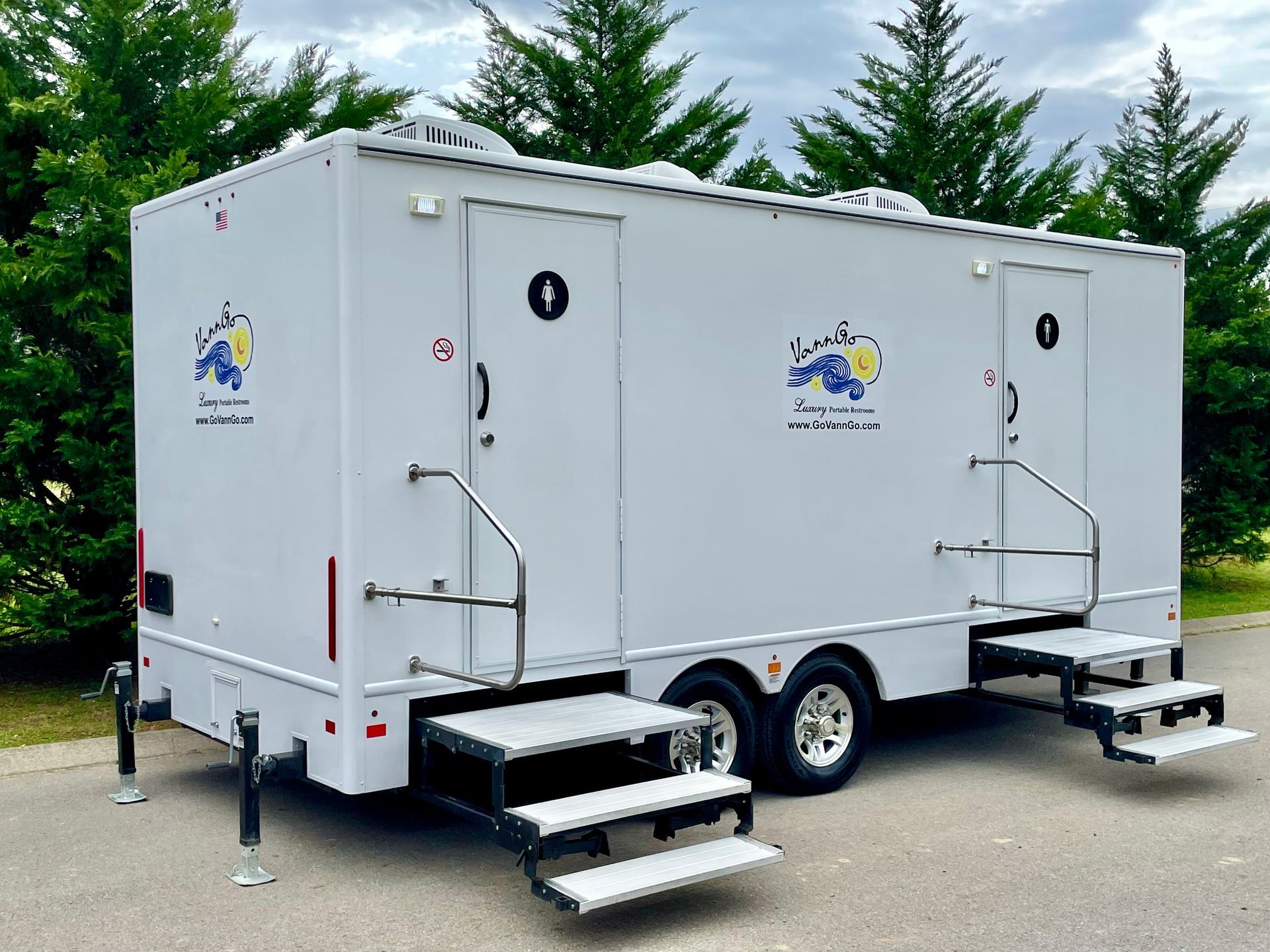 White portable restroom trailer with two separate entrances.