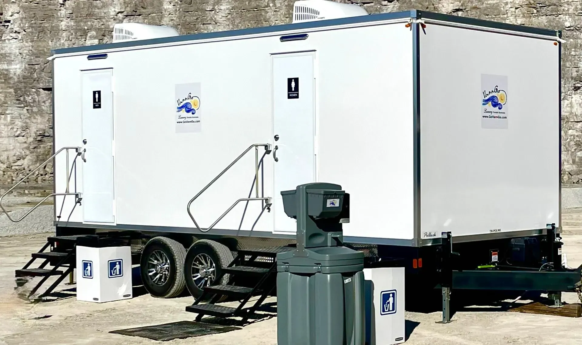 White portable restroom trailer on wheels, with steps.