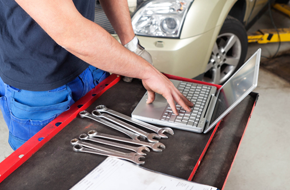 wrenches beside a laptop