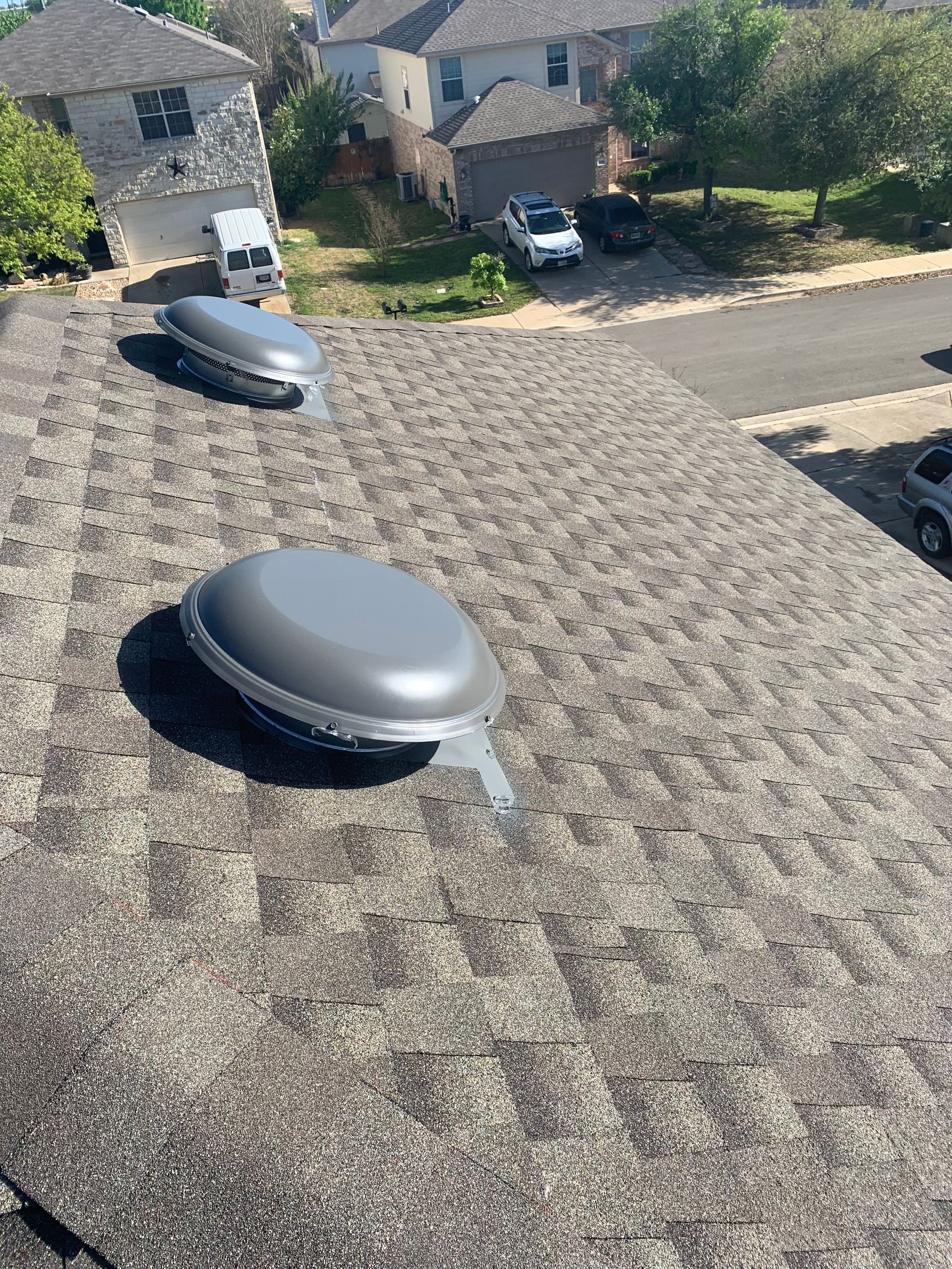 there are two skylights on the roof of a house.