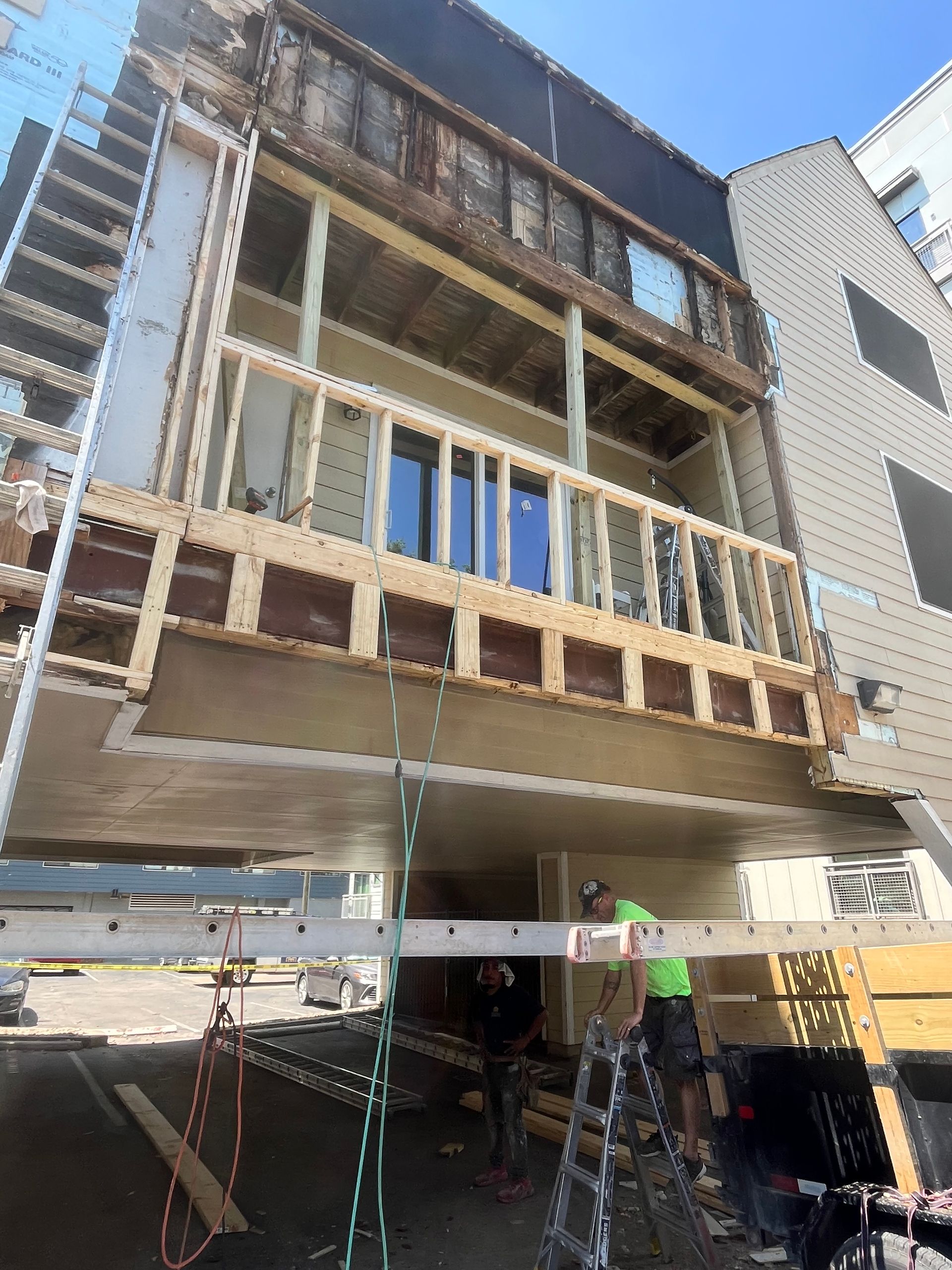 A building is being built with a ladder attached to it.