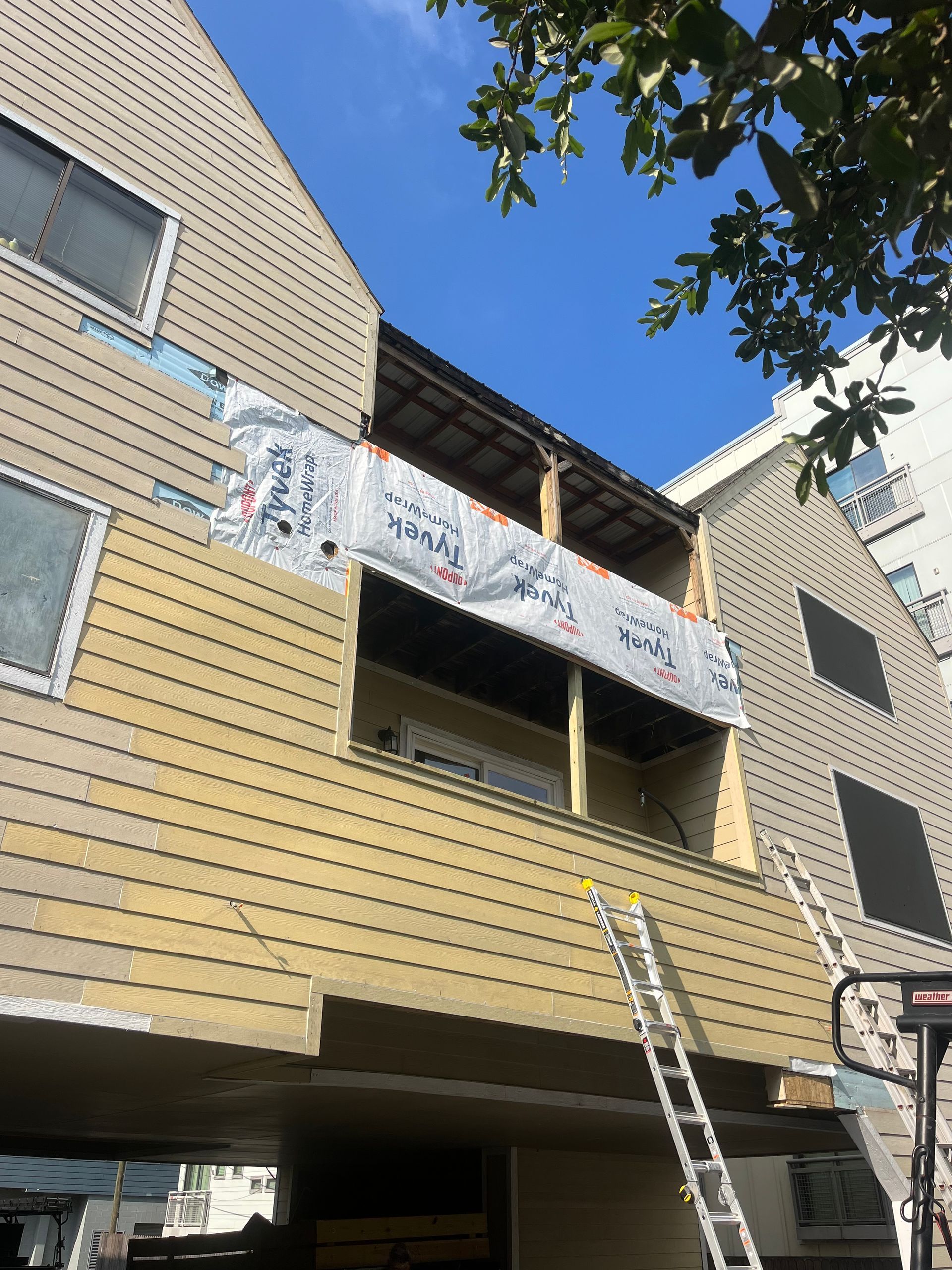 A building with a ladder on the side of it.