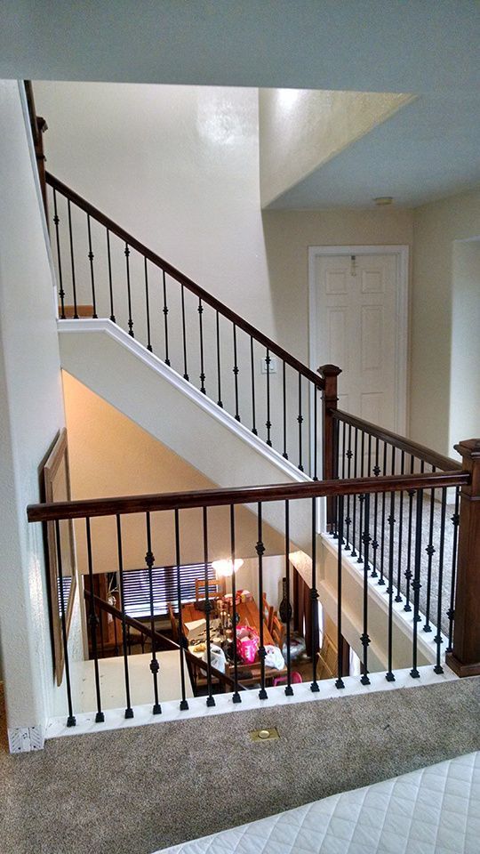 A view of a staircase from the second floor of a house.