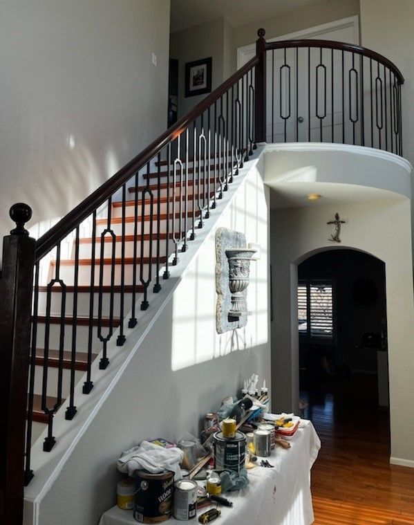 A wooden staircase with a metal railing in a house