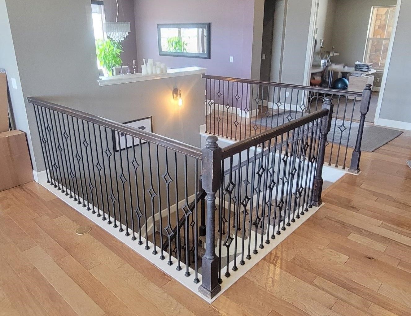 A staircase with a wrought iron railing in a house.