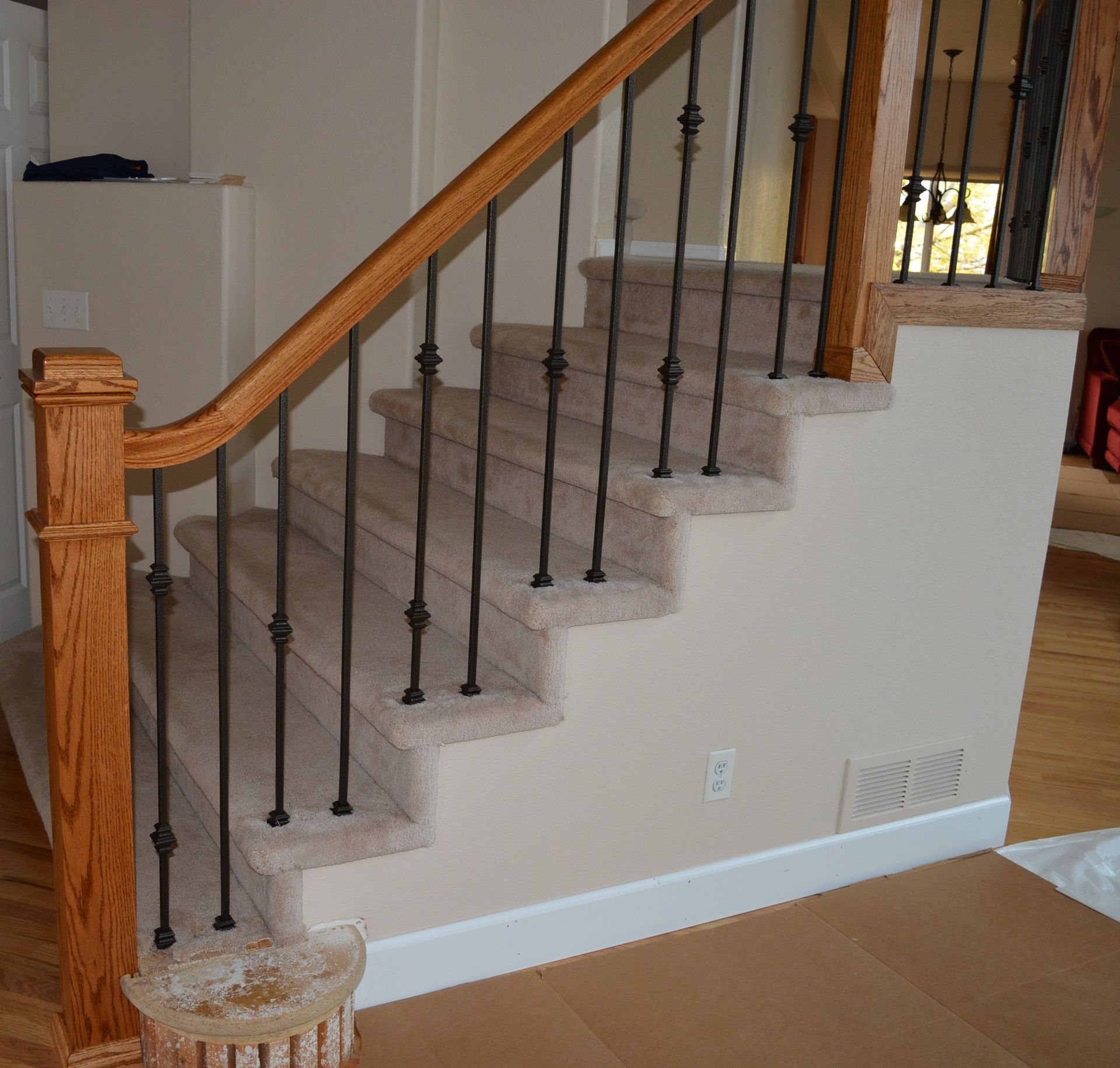 A staircase with a wooden railing and a metal railing