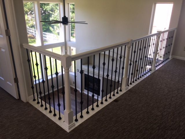 A staircase with a railing and a ceiling fan