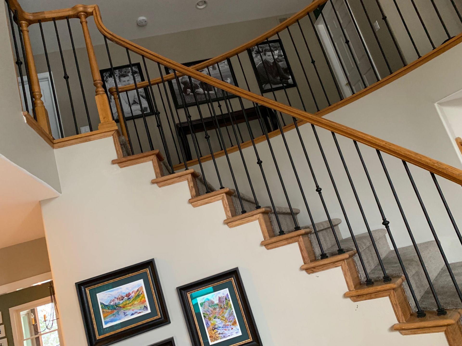 A wooden staircase with a metal railing in a house