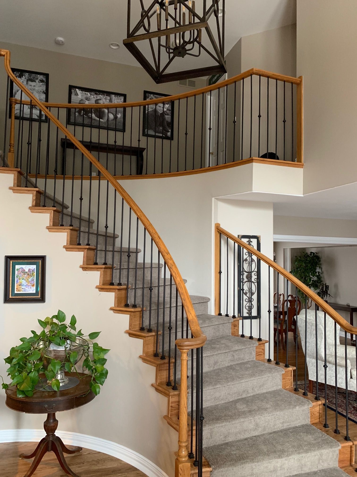 A staircase in a house with a wooden railing and a metal railing