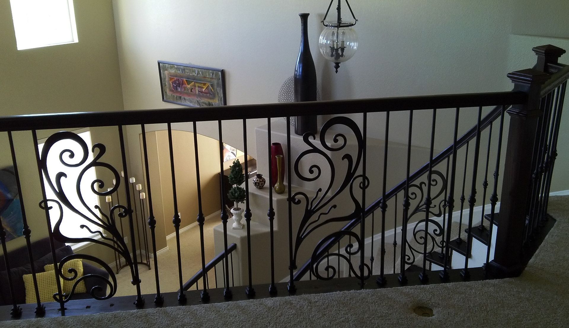 A staircase with a wrought iron railing in a house