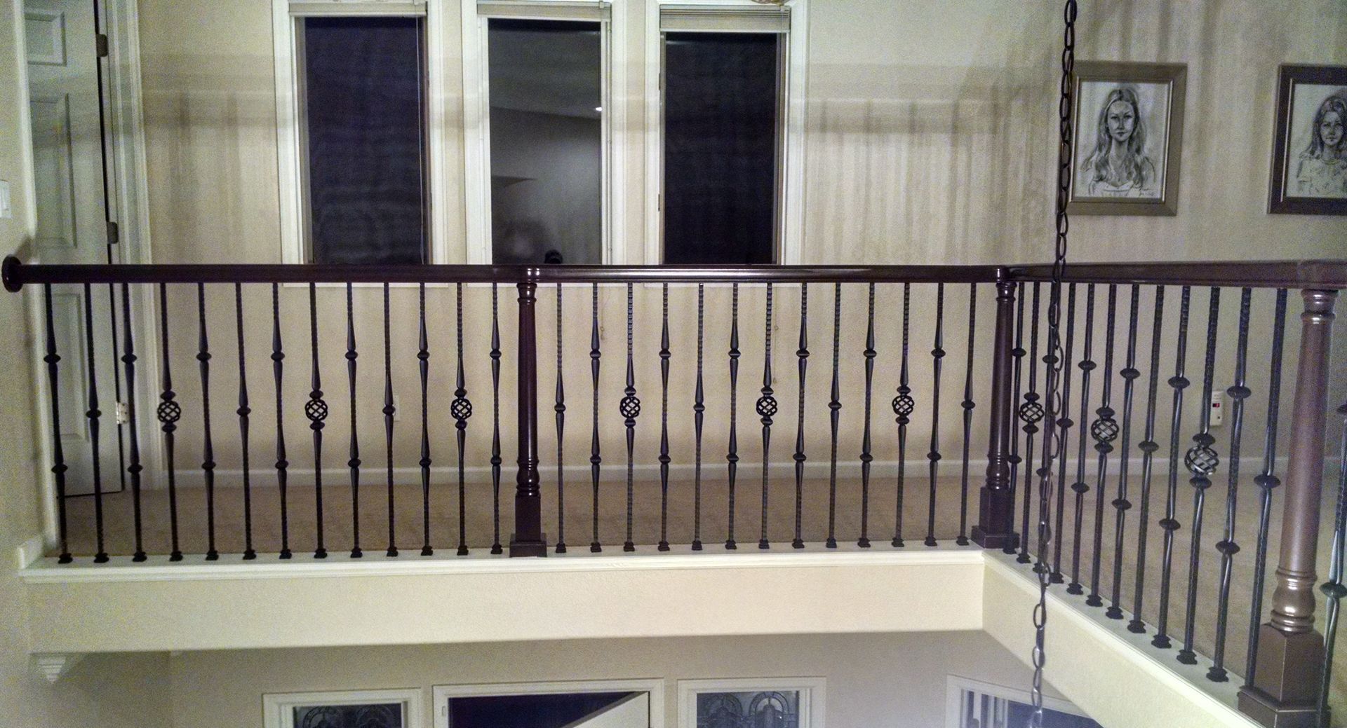 A balcony with a wrought iron railing in a house.