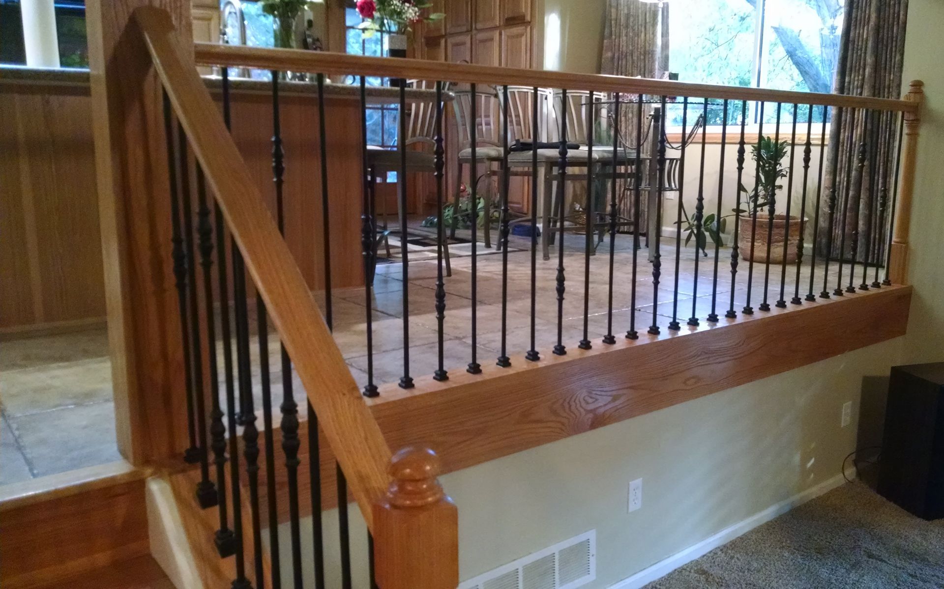 A wooden staircase with a metal railing in a living room