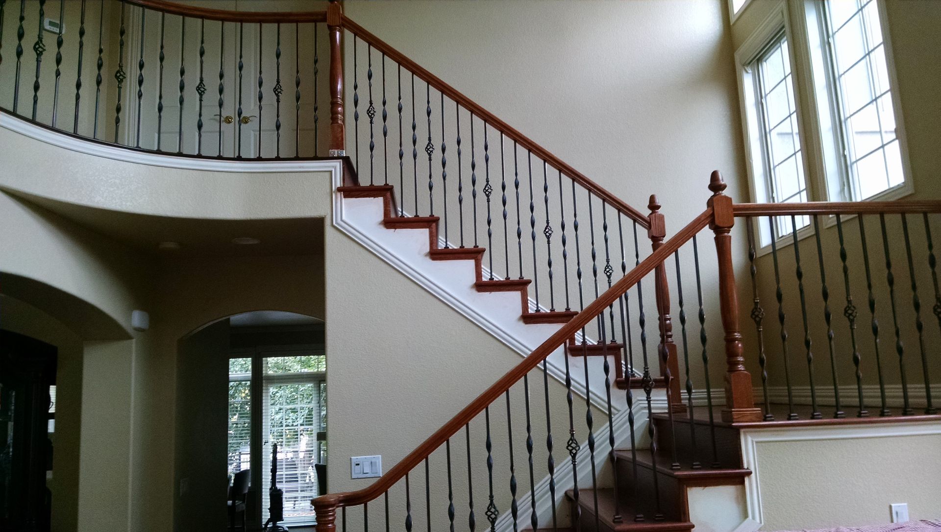 A staircase with a wrought iron railing in a house