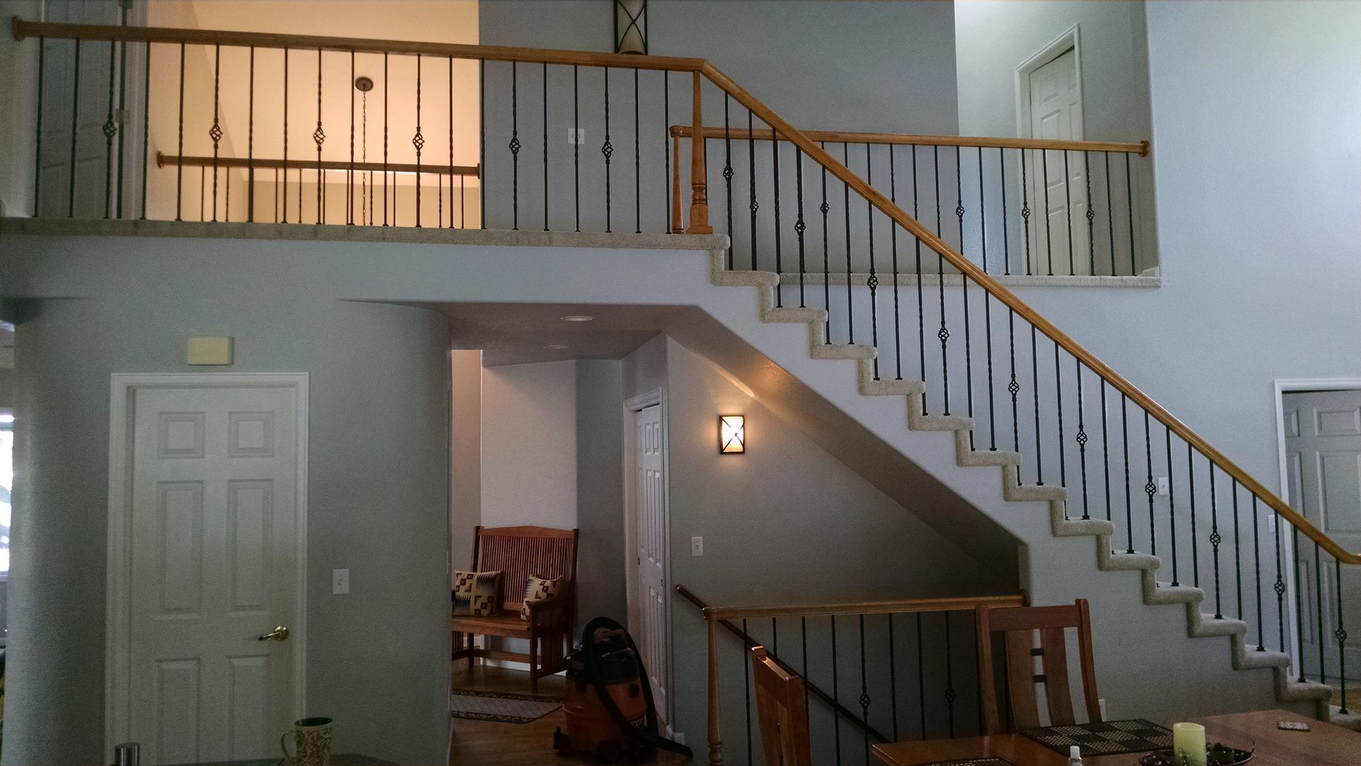 A staircase in a house with a wooden railing