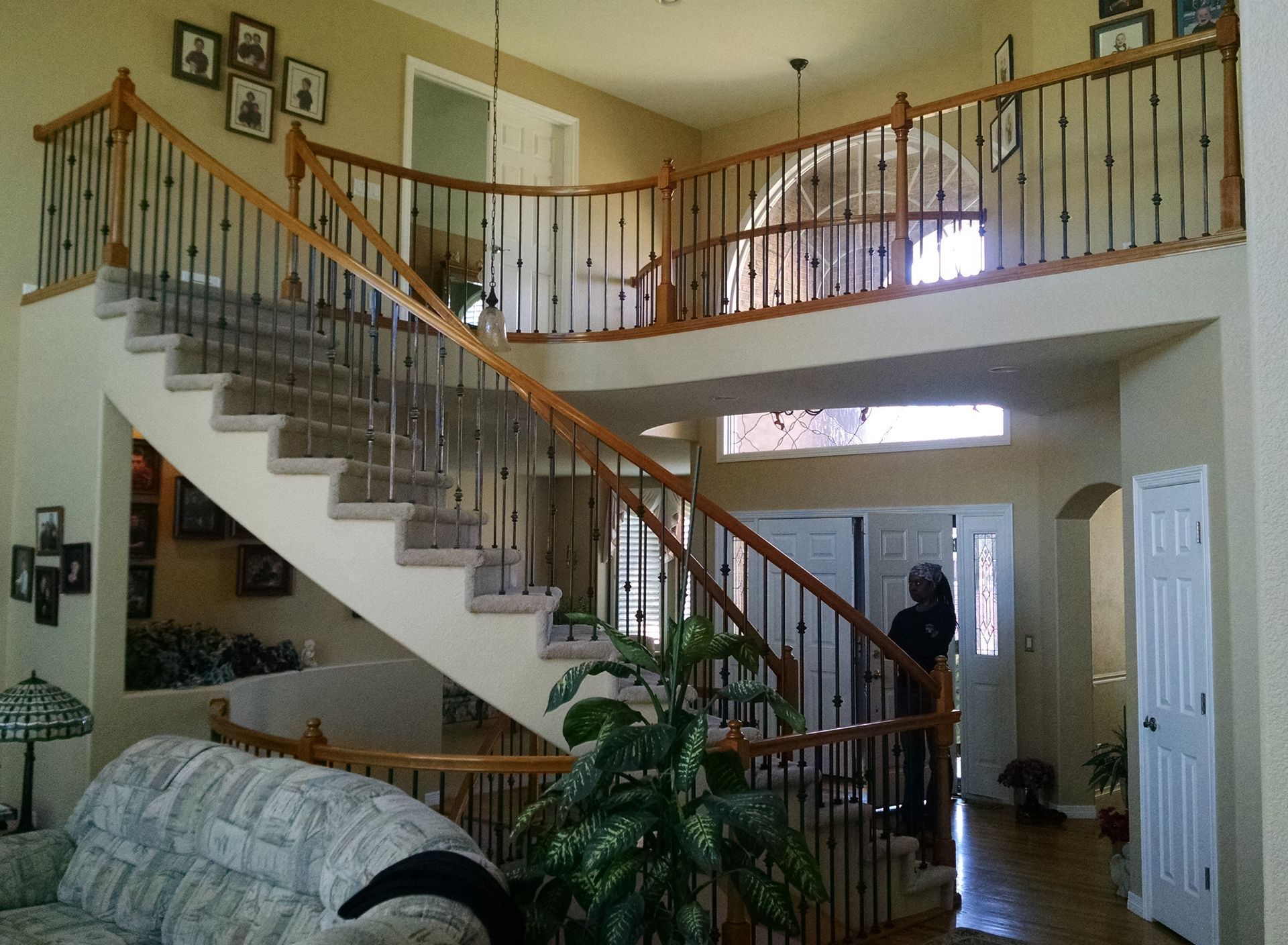 A living room with stairs leading up to the second floor